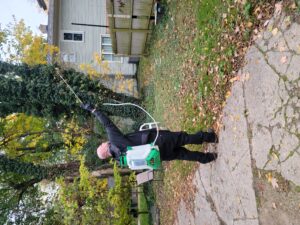 One of our Pest Pros technicians spraying pest control treatment on house in the Fall.