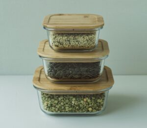 Glass food containers with air-tight lids, representing the importance of proper food storage in pest control.