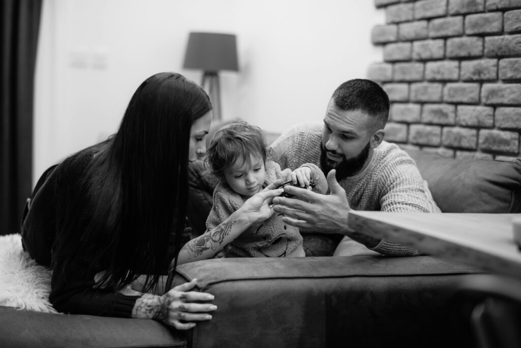 Parents playing with their child at home, signifying enjoying a pest-free home environment.