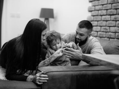 Parents playing with their child at home, signifying enjoying a pest-free home environment.