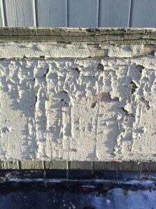 Close-up of a commercial building revealing structural damage caused by termites.