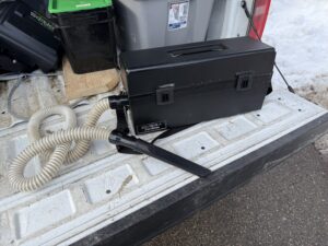 A HEPA (High-Efficiency Particulate Air) vacuum, displayed on the tailgate of a Pest Pros truck.